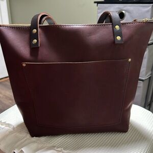 Portland Leather Shoulder Bag Color is like a deep wine color Firm